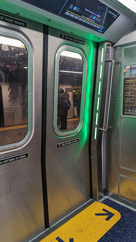 Green lights on the side of opening doors on newer trains