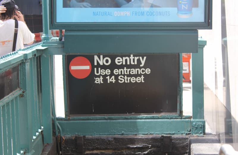 A sign above a subway exit shows that there is 'No Entry'