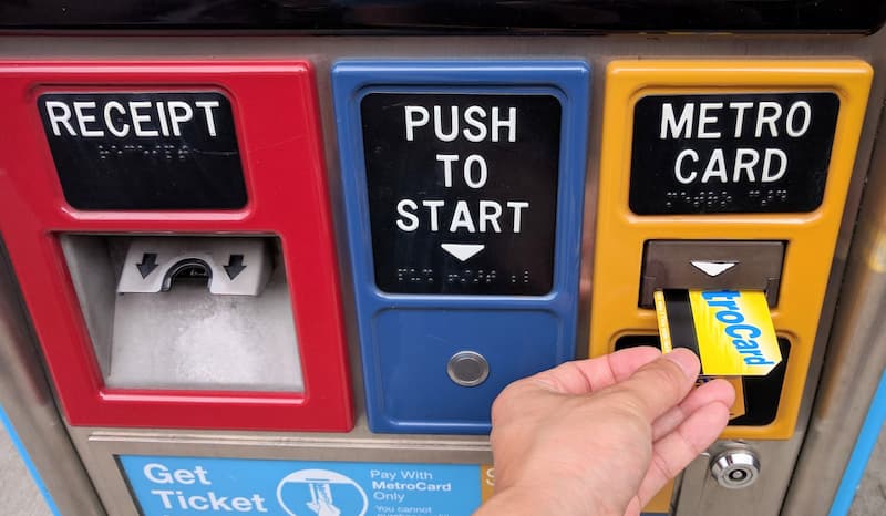 Inserting a MetroCard into a Select Service Bus Fare Payment Machine