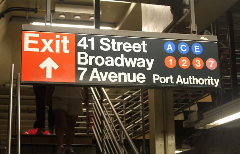 Follow the red exit signs to exit the subway system