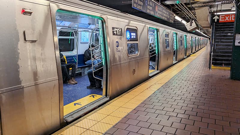 An A train is waiting at the subway platform
